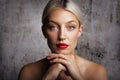 Headshot of blond haired woman wearing red lipstick agains isolated background Royalty Free Stock Photo