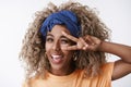 Headshot carefree, relaxed and free attractive african-american blond woman afro hairstyle, blue stylish headband, show