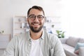 Headshot of cheerful mature european man with beard in glasses look at laptop webcam at minimalist living room Royalty Free Stock Photo