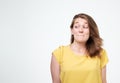 Headshot of cunning beautiful woman in yellow t-shirt looking aside indenting to realize tricky plan. Royalty Free Stock Photo