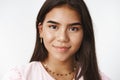 Headshot of cute and friendly-looking sincere indian teenage girl with long dark hair and earrings smiling pleased and Royalty Free Stock Photo