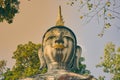 Headshot Front Buddha Statue on Blue Sky Background in Vintage Tone