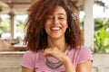 Headshot of glad woman laughs and smiles broadly, expresses positive emotions, has hilarious expression, wears round