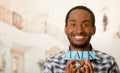 Headshot handsome man holding up small letters spelling the word talk and smiling to camera Royalty Free Stock Photo