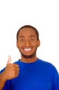 Headshot handsome man wearing strong blue colored t-shirt and giving thumb up smiling to camera