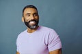 headshot of a handsome smiling african american man with beard and mustache purple shirt on a looking away at copy Royalty Free Stock Photo