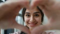 Headshot happy Arabian Indian ethnic millennial woman student girl businesswoman near window female homeowner freelancer