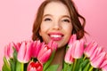 headshot of happy woman with bouquet of spring flowers