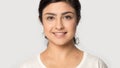 Headshot of indian girl look at camera posing in studio