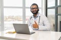 Headshot of intelligent professional Indian male doctor shows thumb up