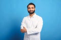 Headshot of intelligent professional Indian male doctor wearing medical white gown looking at the camera Royalty Free Stock Photo