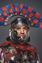 Headshot of isolated on gray roman warrior with plumed helmet