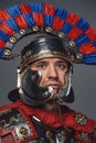 Headshot of isolated on gray roman warrior with plumed helmet