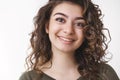 Headshot lucky dreamy cute armenian woman curly hairstyle smiling hopefully upbeat positive mood enjoying nice friendly