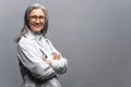 Headshot of mature female doctor , looking at the camera isolated on gray Royalty Free Stock Photo