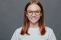 Headshot of pleasant looking dark haired young woman wears transparent glasses, dressed in casual clothes, has healthy skin, Royalty Free Stock Photo