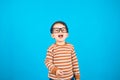 Headshot of pleased hipster baby boy has fun expression wears transparent glasses and striped sweater. Royalty Free Stock Photo