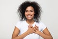 Headshot portrait american woman holding hand on heart feels gratitude