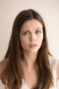 Headshot portrait of disappointed young woman