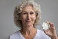 Portrait of senior woman recommend facial cream