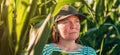 Headshot portrait of female farm worker in cultivated corn crop field