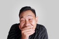 Funny Asian man smiling shy close his mouth Royalty Free Stock Photo