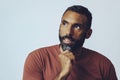 headshot portrait of a handsome bearded mid adult man smiling looking away at copy space against gray background Royalty Free Stock Photo