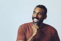 headshot portrait of a handsome bearded mid adult man smiling looking away at copy space against gray background Royalty Free Stock Photo