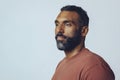 headshot portrait of a handsome bearded mid man looking away at copy space against gray background