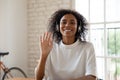 Smiling biracial woman wave having video call in office Royalty Free Stock Photo