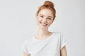 Headshot Portrait of happy ginger girl with freckles smiling looking at camera. White background. Royalty Free Stock Photo