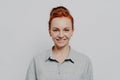 Headshot portrait of happy young caucasian ginger woman being satisfied and feeling happy Royalty Free Stock Photo