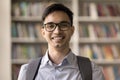 Headshot portrait of Indian student guy standing in campus library Royalty Free Stock Photo