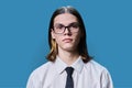 Headshot portrait of serious teenage guy on blue studio background Royalty Free Stock Photo