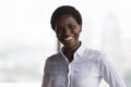 Headshot portrait smiling African businesswoman posing in office