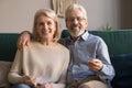 Headshot portrait of smiling mature couple sit on couch Royalty Free Stock Photo