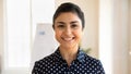 Headshot portrait of smiling indian female employee pose in office Royalty Free Stock Photo