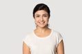 Headshot portrait of smiling indian girl posing in studio