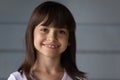 Headshot portrait of happy Hispanic girl look at camera