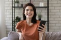 Headshot portrait of smiling millennial girl using cellphone