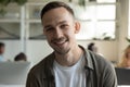 Headshot of smiling male employee talk on video call