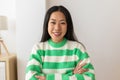 Headshot portrait of smiling young adult chinese woman smiling at camera