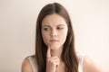 Headshot portrait of thoughtful young woman