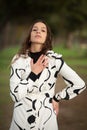 Headshot portrait of a young woman with long hair wearing black and white dress posing fashion outdoors Royalty Free Stock Photo