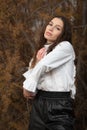 Headshot portrait of a young woman with long hair wearing black and white dress posing outdoors. Royalty Free Stock Photo