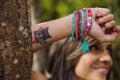 Headshot pretty brunette, standing between trees, bare skinned arms above head pose, sensually looking into camera Royalty Free Stock Photo