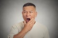 Headshot sleepy middle aged business man yawning Royalty Free Stock Photo