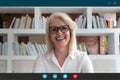 Headshot of smiling mature woman speak on video call