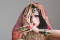 Headshot woman dressed in traditional hindu clothing, heavily decorated in gold and elegant veil, extremely long