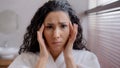 Headshot worried frustrated young woman looking in mirror in bathroom worrying about first wrinkles in eye area unhappy Royalty Free Stock Photo